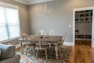 Informal kitchen dining room with a large window, natural light and hardwood floors perfect for family dinners