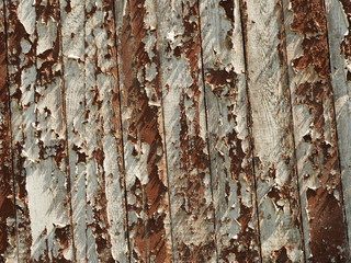 Obraz premium Old wooden background with peeling paint. Vintage background - an old wooden Board painted in red.