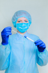 the doctor holds in his hands a container for sampling