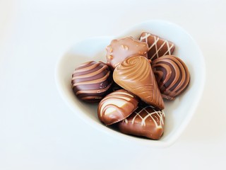 chocolate in heart cup on white background 