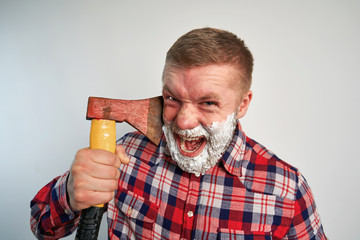 man shaves with an axe on a white background