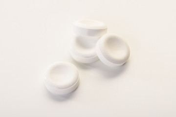 Large white round vitamin pills on a white background.
