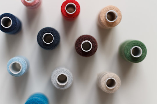 close-up of colored sewing threads on a light background with a place for the inscription. the view from the top