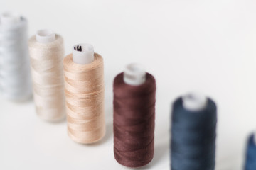 close-up of colored sewing threads on a light background with a place for the inscription.