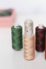 close-up of colored sewing threads on a light background with a place for the inscription.