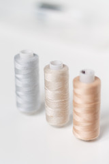 close-up of colored sewing threads on a light background with a place for the inscription.