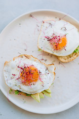 Healthy food concept. Tasty sandwich with avocado and fried eggs