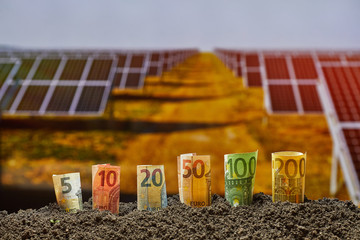 Euro bills and new energy solar panels . Sustainable resources. Money, Finance concept