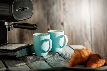 Coffee on a wooden table in the glow of the morning sun