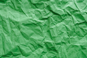 Crumpled green carton paper, blank abstract background, copy space.