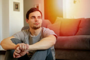 A man doing exercises and resting at home. Healthy lifestyle concept