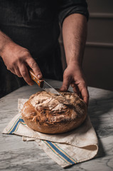 Man cutting homemade organic bread
