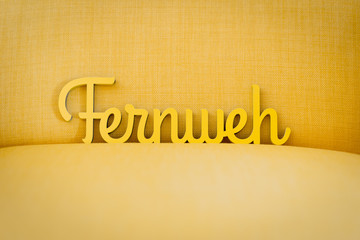 A sign for wanderlust (Fernweh), travel, adventure and holidays; yellow