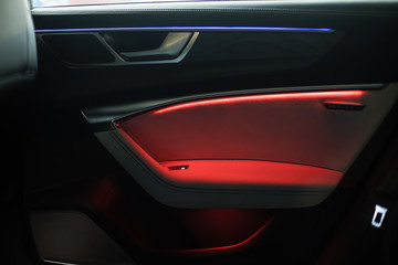 Obraz na płótnie Canvas night ambient led light inside of car interior. door card
