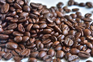 Roasted Coffee beans background with selective focus. Arabica coffee seeds. 
