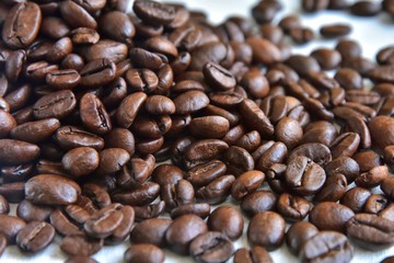 Roasted Coffee beans background with selective focus. Arabica coffee seeds. 
