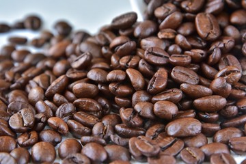 Roasted Coffee beans background with selective focus. Arabica coffee seeds. 
