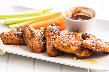 Grilled chicken wings with BBQ sauce.