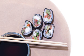 Keto diet. Rolls of cabbage, cucumber and red fish. Chopsticks and Soy Sauce