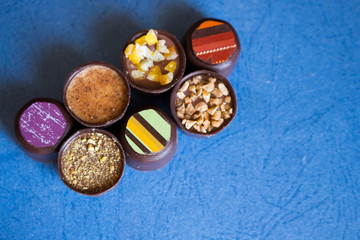 Various of sweet confectionery with chocolate candies and pralines. Handmade box of chocolates. Realistic chocolate set, delicious dessert pattern.