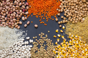 Different type of raw dry legumes composition. White beans, lentils, bulgur, chickpeas, kidney beans, corns, rice,  Mix organic legume concept, copy space