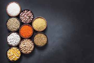Different type of raw dry legumes composition. White beans, lentils, bulgur, chickpeas, kidney beans, corns, rice,  Mix organic legume concept, copy space