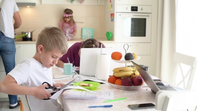 Father At Home With Three Kids, Alone, Single, Cooking And Taking Care Of Children Of Different Ages