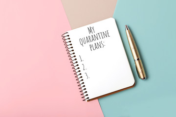 Notebook with the list of the quarantine 2020 plans list.Pastel background with pink,grey and blue...