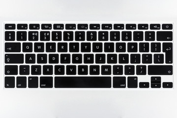 Close up top view on a laptop keyboard with flat buttons