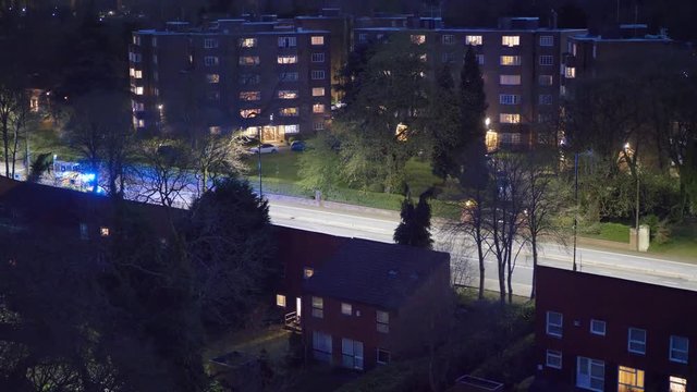 Ambulance With Blue Flashing Lights.

UK Ambulance On An Emergency Call Shot From A High Angle At Night.