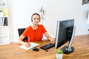 Woman using headset and pc for work