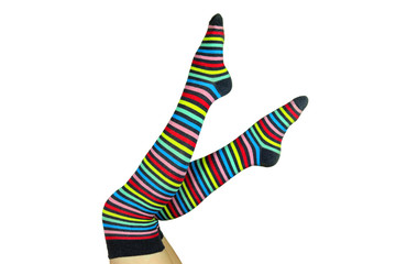 female legs in striped colorful socks.