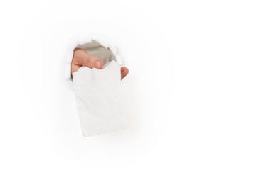 Obraz premium Hand delivers toilet paper through hole in the wall