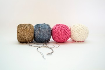 Four spools of thread in a row