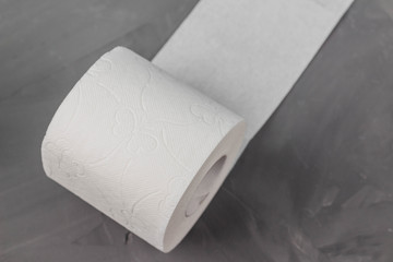 One toilet paper rolls on a gray background