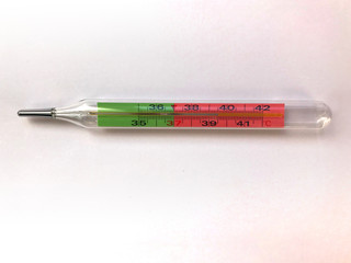 female hand holds a thermometer. thermometer shows heat, high temperature