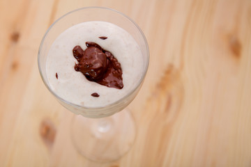 Top view of ice cream smoothie with banana and chocolate.