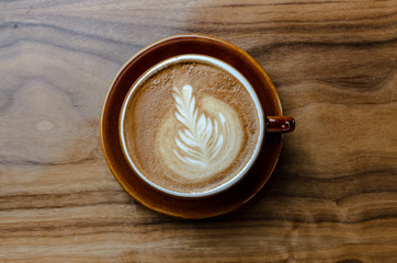 Latte cup of coffee on wooden table