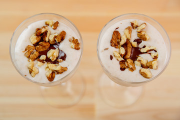 Glasses with ready smoothie chocolate ice cream banana smoothie and nuts.