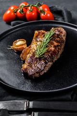 Beef strip loin steak on black background.  Marble premium beef