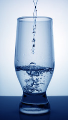 pure fresh water is poured into a glass