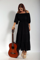 Pretty woman with a guitar on white background