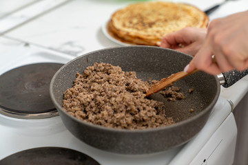 cooking delicious pancakes with meat filling