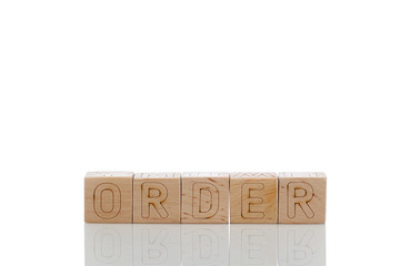 Wooden cubes with letters order on a white background