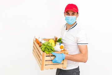 Courier's hands in latex white medical gloves deliver parcels in brown cardboard boxes to the door during the epidemic of coronovirus,COVID-19. Safe delivery of online orders during the epidemic.