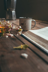 Flowers, coffee and book on the table