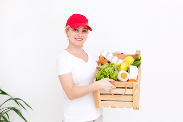 delivery girl wearing red uniform presenting the parcel box closeup