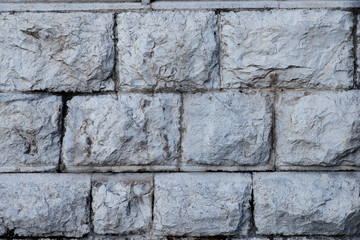 Texture of stone wall made of grey stones