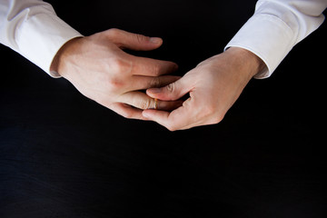 A man removes a wedding ring from his finger. This is a divorce.