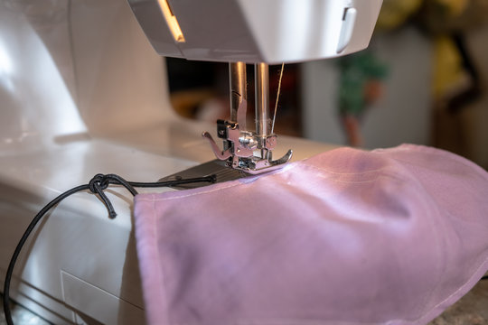 Sewing A Face Mask At Home Due To Covid-19 Epidemic, Sewing Machine Close Up With Cotton Fabric